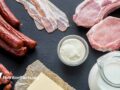 Assortment of dairy and meat products on dark countertop