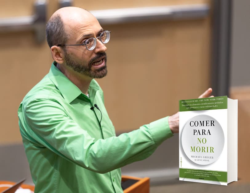 Dr. Greger in a green shirt gesturing towards audience